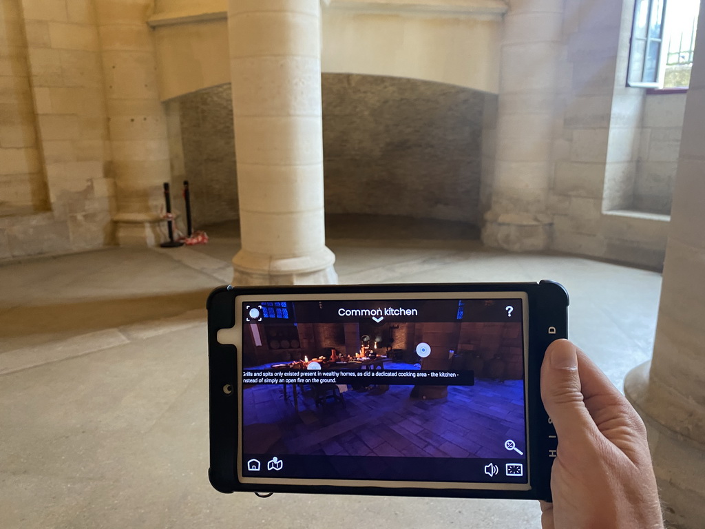 Tim with an iPad showing what the Kitchen looked like, at the Kitchen at the Conciergerie building