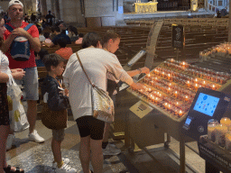 Miaomiao and Max lighting a candle at the nave of the Basilique du Sacré-Coeur church