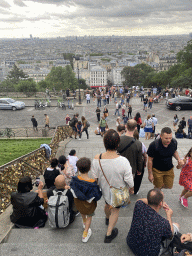 Miaomiao and Max at the staircase from the Parvis du Sacré-Coeur square to the Square Louise Michel, with a view on the city center