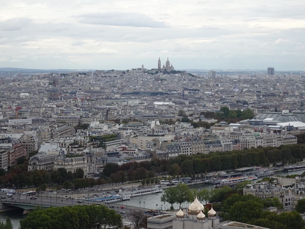 The Seine river, the Cathédrale de la Sainte-Trinité de Paris cathedral, the Église Saint-Augustin church and the Montmartre hill with the Basilique du Sacré-Coeur church, viewed from the Second Floor of the Eiffel Tower