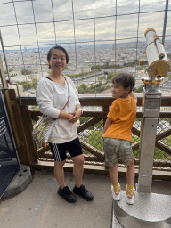 Miaomiao and Max at the Second Floor of the Eiffel Tower, with a view on the Seine river and the Montmartre hill with the Basilique du Sacré-Coeur church