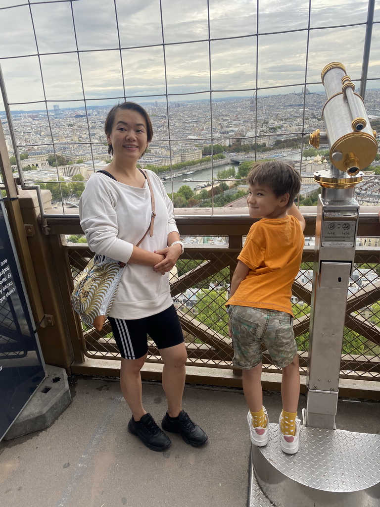 Miaomiao and Max at the Second Floor of the Eiffel Tower, with a view on the Seine river and the Montmartre hill with the Basilique du Sacré-Coeur church