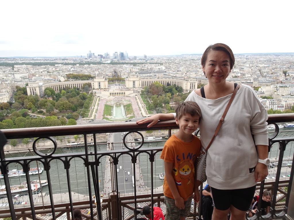 Miaomiao and Max at the Second Floor of the Eiffel Tower, with a view on the Pont d`Iéna bridge over the Seine river, the Jardins du Trocadéro gardens, the Palais de Chaillot palace, the Bois de Boulogne park with the Louis Vuitton Foundation museum and the La Défense district with the Grande Arche de la Défense building