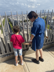 Miaomiao and Max on the roof of the Arc de Triomphe, with a view on the Avenue des Champs-Élysées and the Tour Montparnasse tower
