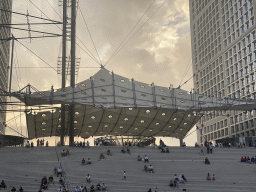 Staircase and canvas at the Grande Arche de la Défense building, viewed from the Parvis de la Défense square, at sunset