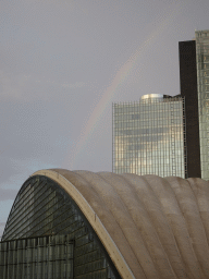 Rainbow above the CNIT shopping mall and skyscrapers at the Parvis de la Défense square, at sunset