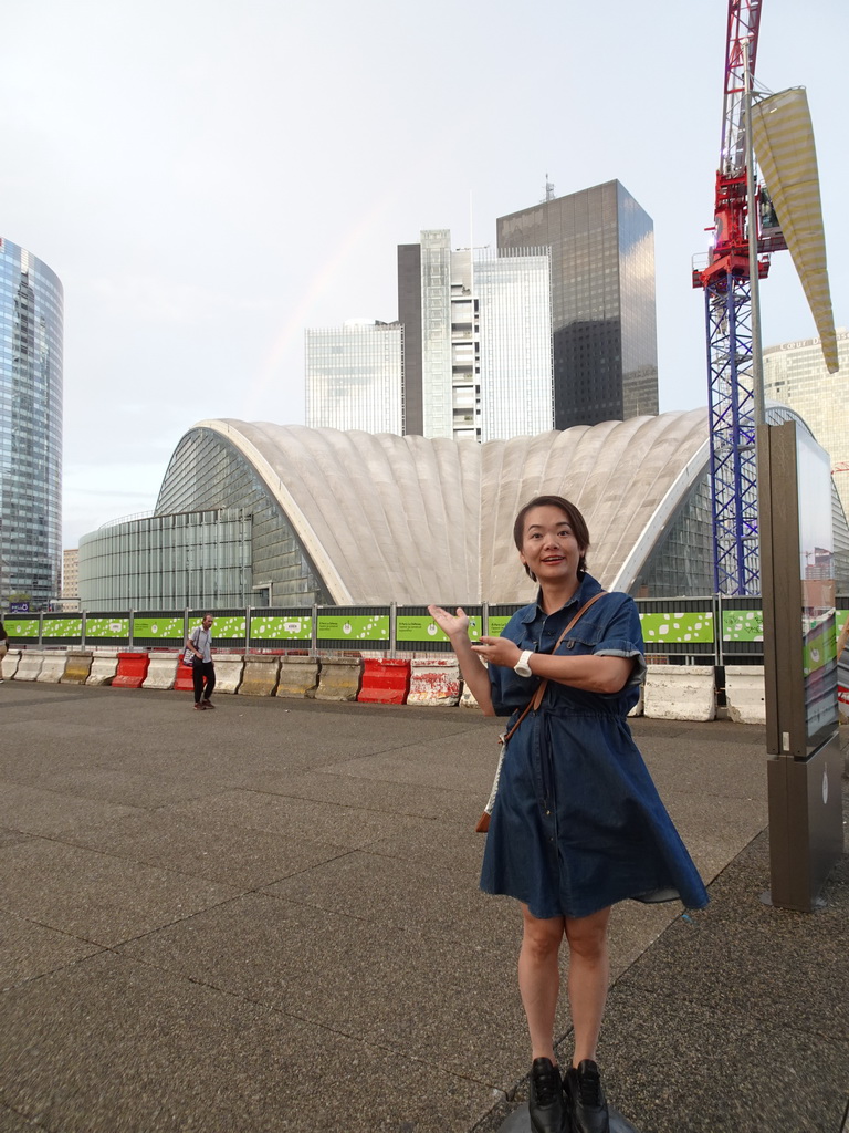 Miaomiao in front of the CNIT shopping mall and skyscrapers at the Parvis de la Défense square, at sunset