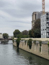 The Pont au Double bridge over the Seine river and the towers of the Cathedral Notre Dame de Paris, under renovation, viewed from the Pont de l`Archevêché bridge