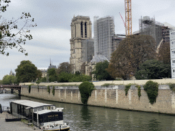 The Pont au Double bridge over the Seine river and the southwest side of the Cathedral Notre Dame de Paris, under renovation, viewed from the Quai de la Tournelle street