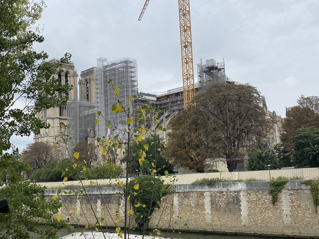 The Seine river and the southwest side of the Cathedral Notre Dame de Paris, under renovation, viewed from the Quai de la Tournelle street