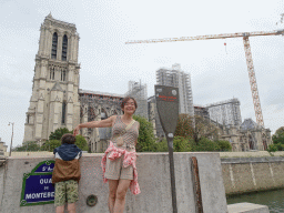 Miaomiao and Max at the Quai de Montebello street, with a view on the southwest side of the Cathedral Notre Dame de Paris, under renovation