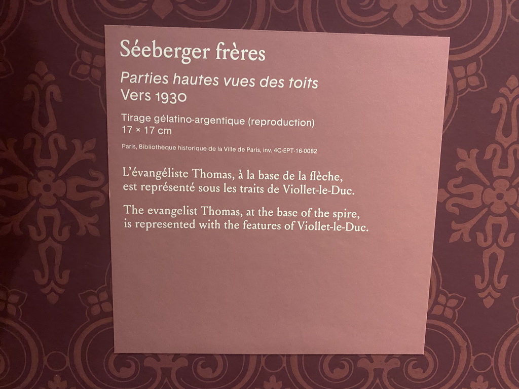 Explanation on the old photograph of a statue of evangelist Thomas and the spire of the Cathedral Notre Dame de Paris at the Archaeological Crypt of the Île de la Cité