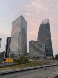 Front of the Pullman Paris La Défense hotel and skyscrapers at the Avenue de l`Arche, viewed from the Parvis de la Défense square, at sunset