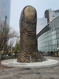 Max with the Le Pouce statue at the Parvis de la Défense square, at sunset