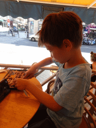 Max eating a waffle with chocolate at the Crêperie restaurant at the Rue Soufflot street