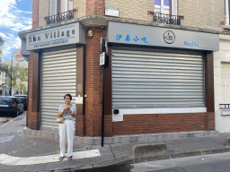 Miaomiao in front of the Sha Village restaurant at the Rue de l`Ouest street