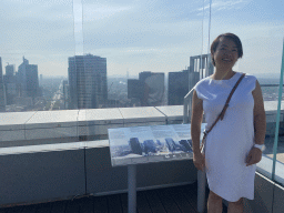 Miaomiao at the observation deck at the top floor of the Grande Arche de la Défense building, with a view on the skyscrapers at the La Défense district, the Avenue Charles de Gaulle, the Arc de Triomphe, the Louis Vuitton Foundation museum and the Eiffel Tower