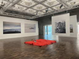 Max on a mattress at the exhibition `Hymne à la Beauté` at the top floor of the Grande Arche de la Défense building