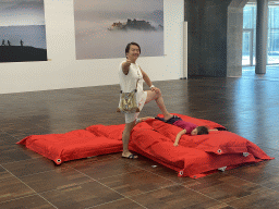 Miaomiao and Max on a mattress at the exhibition `Hymne à la Beauté` at the top floor of the Grande Arche de la Défense building