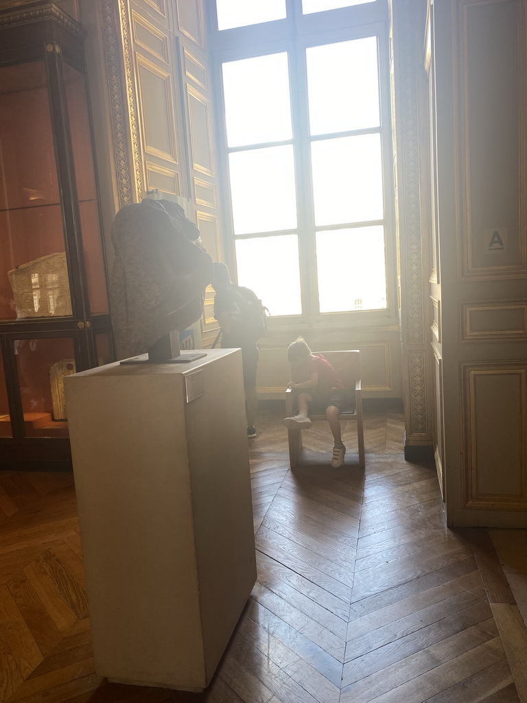 Max on a chair at the First Floor of the Sully Wing of the Louvre Museum
