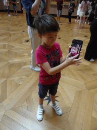 Max with iPhone at the First Floor of the Denon Wing of the Louvre Museum, with explanation