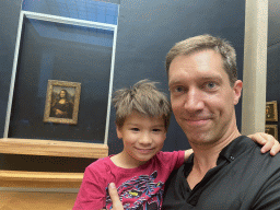 Tim and Max in front of the painting `Mona Lisa` by Leonardo da Vinci at the First Floor of the Denon Wing of the Louvre Museum