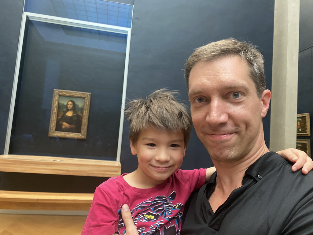 Tim and Max in front of the painting `Mona Lisa` by Leonardo da Vinci at the First Floor of the Denon Wing of the Louvre Museum