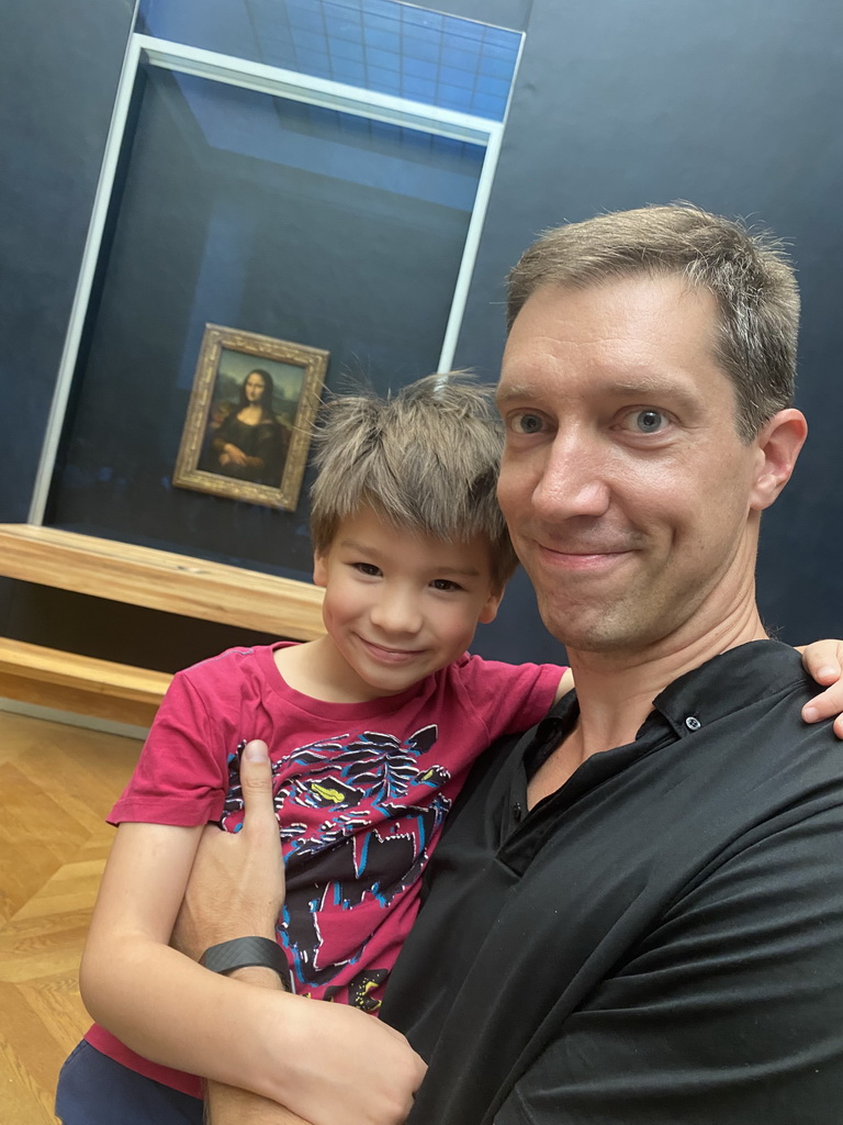 Tim and Max in front of the painting `Mona Lisa` by Leonardo da Vinci at the First Floor of the Denon Wing of the Louvre Museum