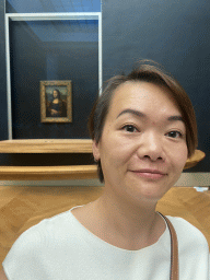 Miaomiao in front of the painting `Mona Lisa` by Leonardo da Vinci at the First Floor of the Denon Wing of the Louvre Museum