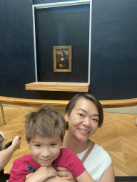 Miaomiao and Max in front of the painting `Mona Lisa` by Leonardo da Vinci at the First Floor of the Denon Wing of the Louvre Museum