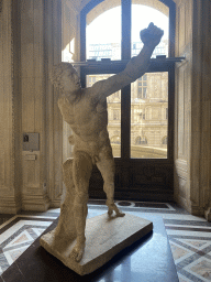 Statue `Gladiateur Borghèse` at the Roman Antiquities section at the Ground Floor of the Denon Wing of the Louvre Museum, with explanation