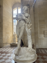 Statue `Silenus carrying Dionysos` at the Salle des Cariatides room at the Ground Floor of the Sully Wing of the Louvre Museum