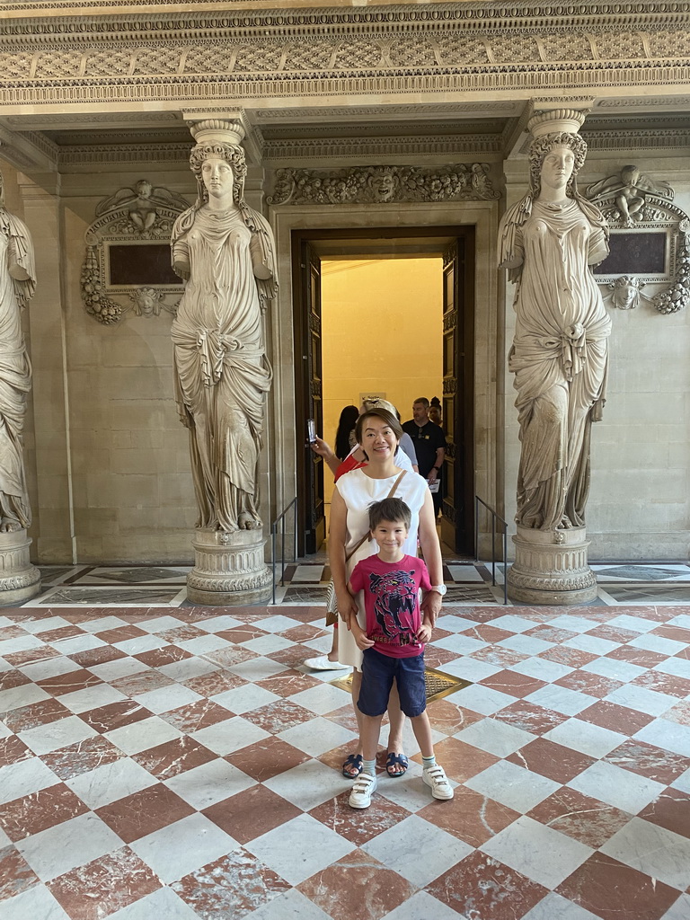 Miaomiao and Max with the Caryatid statues at the Salle des Cariatides room at the Ground Floor of the Sully Wing of the Louvre Museum