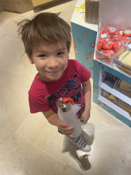 Max with a drinking bottle at a souvenir shop at the Lower Ground Floor of the Louvre Museum