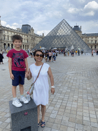 Miaomiao and Max in front of the Louvre Pyramid and the Sully Wing of the Louvre Museum at the Cour Napoléon courtyard