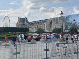 The Tuileries Gardens with the Ferris Wheel and the Marsan Wing of the Louvre Museum at the Cour Napoléon courtyard