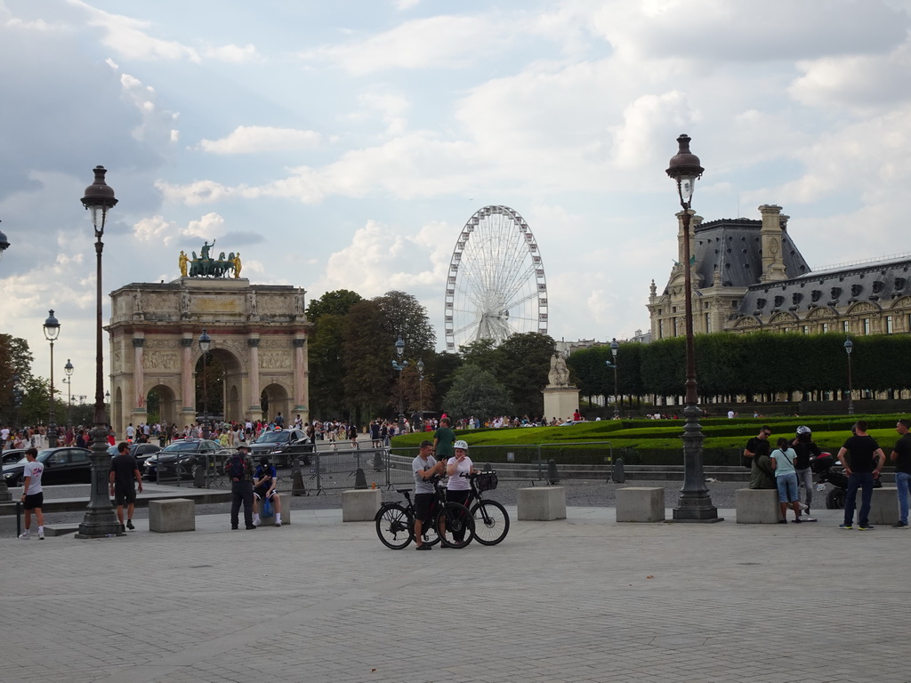The Place du Caroussel square with the Arc de Triomphe du Carrousel, the Tuileries Gardens with the Ferris Wheel and the Marsan Wing of the Louvre Museum, viewed from the Cour Napoléon courtyard