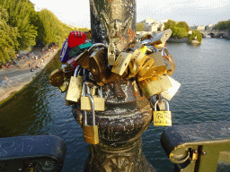 Locks at the Pont des Arts bridge over the Seine river, with a view on the Pont Neuf bridge and the Île de la Cité island