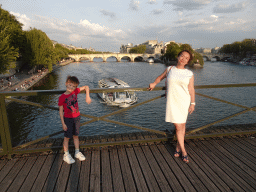 Miaomiao and Max at the Pont des Arts bridge over the Seine river, with a view on the Pont Neuf bridge and the Île de la Cité island
