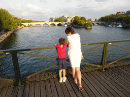 Miaomiao and Max at the Pont des Arts bridge over the Seine river, with a view on the Pont Neuf bridge and the Île de la Cité island
