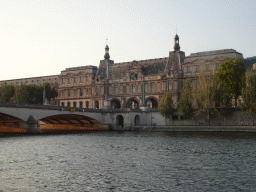 The Pont du Carrousel bridge over the Seine river and the Pavillon de la Trémoille pavilion at the southwest side of the Louvre Museum, viewed from the Promenade Marceline Loridan-Ivens