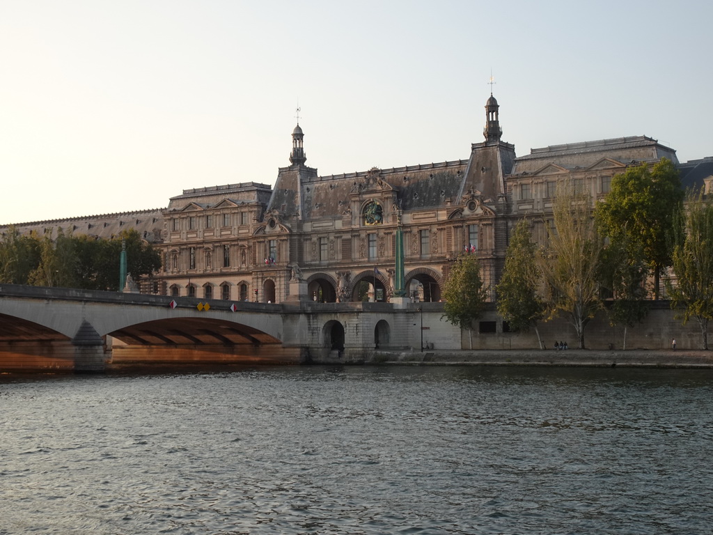 The Pont du Carrousel bridge over the Seine river and the Pavillon de la Trémoille pavilion at the southwest side of the Louvre Museum, viewed from the Promenade Marceline Loridan-Ivens