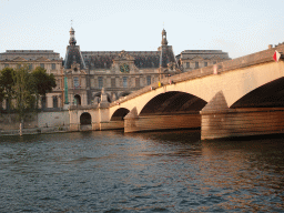 The Pont du Carrousel bridge over the Seine river and the Pavillon de la Trémoille pavilion at the southwest side of the Louvre Museum, viewed from the Promenade Marceline Loridan-Ivens