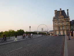 The Pont Royal bridge over the Seine river, the Tuileries Gardens with the Ferris Wheel and the École du Louvre building