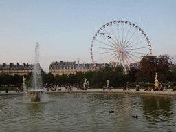 Fountain at the Grand Bassin Rond pond and Ferris Wheel at the Tuileries Gardens