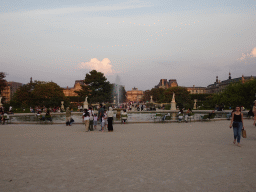 Fountain at the Grand Bassin Rond pond at the Tuileries Gardens, the west side of the Arc de Triomphe du Carrousel at the Jardin du Carrousel garden and the Louvre Museum