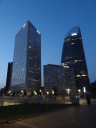 Front of the Pullman Paris La Défense hotel and skyscrapers at the Avenue de l`Arche, viewed from the Parvis de la Défense square, by night