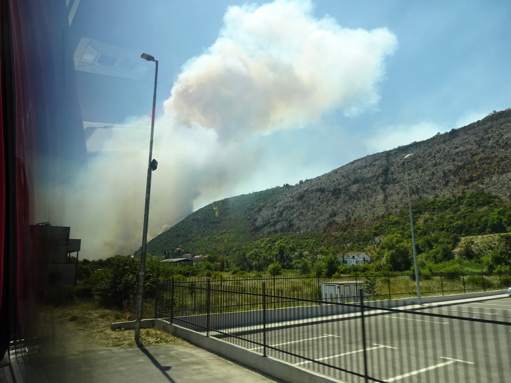 Smoke from a forest fire near the town of Njivice, viewed from the tour bus on the E65 road at the town of Sutorina