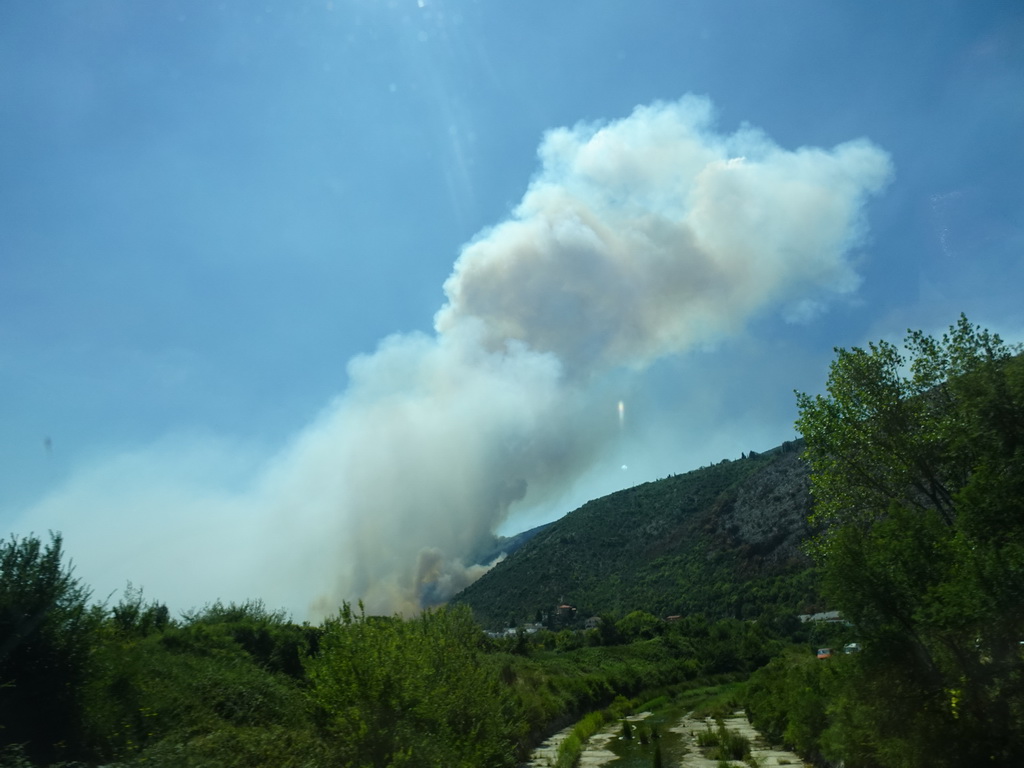 Smoke from a forest fire near the town of Njivice, viewed from the tour bus on the E65 road at the town of Sutorina