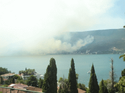 The Bay of Kotor and smoke from a forest fire near the town of Njivice, viewed from the tour bus on the E65 road at the town of Herceg Novi